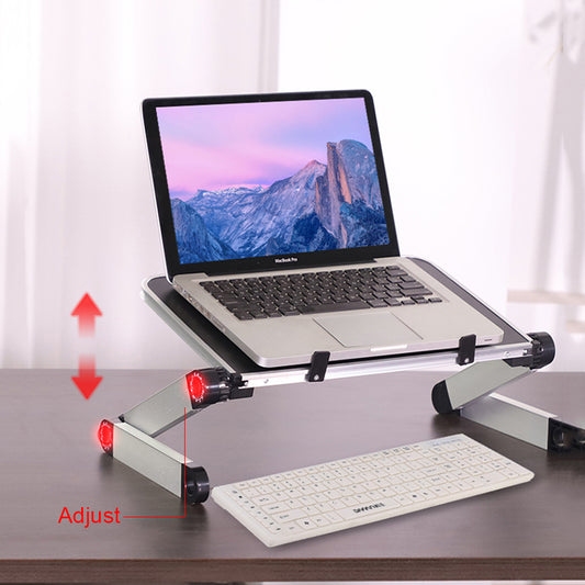 Laptop on a adjustable stand with keyboard on a desk, against a white curtain background